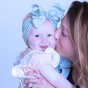 mom kissing baby