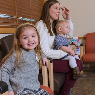 Young faminly in clinic waiting room